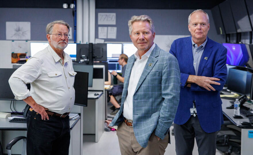 U.S. Sen. Gary Peters, left, Michigan State University President Kevin Guskiewicz, center, and Facility for Rare Isotope Beams Laboratory Director Thomas Glasmacher, right, tour the FRIB in East Lansing, Mich., on Aug. 28, 2026. The visit was the last stop on Peters' final motorcycle tour of Michigan as senator.