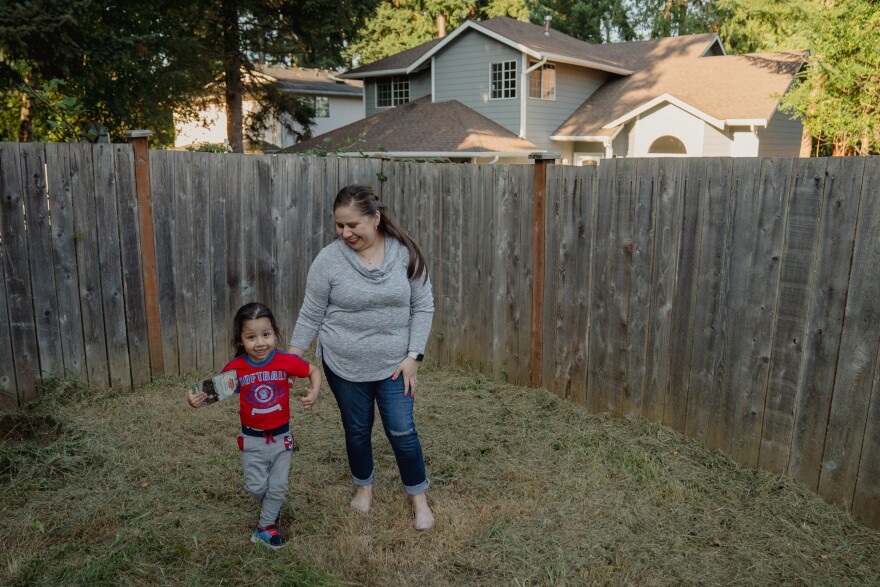 Lopez, right, plays with her son, Keivin Alfaro Lopez, 3.