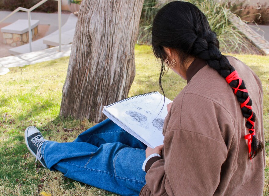 An El Paso student sketches a drawing in a pad during her free time. Her family and others with mixed status relatives have changed daily habits amid an ICE crackdown.