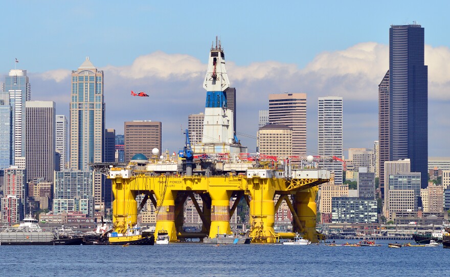 Foss Maritime tugs pull the Polar Pioneer past downtown Seattle on the way to Terminal 5 on Thursday, May 14, 2015.
