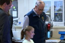 Indiana governor Mike Braun and Bloomfield schools superintendent Scott Van Der Aa watch as a Bloomfield High School student shows classwork on a computer Monday in Bloomfield.