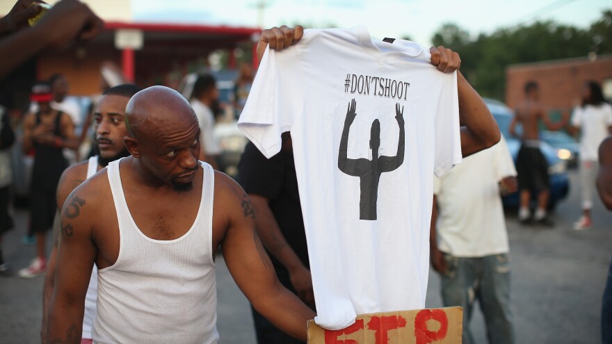 Demonstrators protest the killing of Michael Brown, 18, who was shot and killed by police Saturday in Ferguson, Mo.