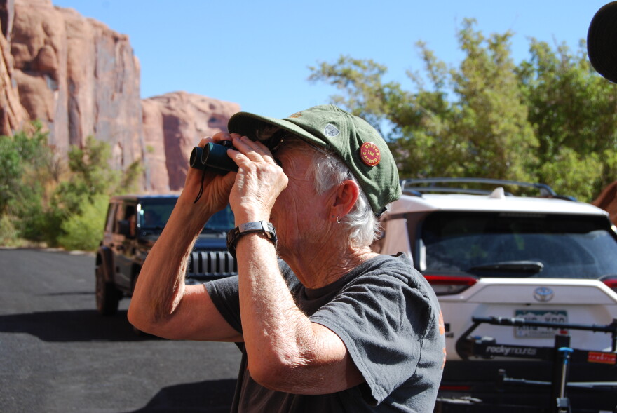 Rachel Smith looks up at a petroglyph panel along the Colorado River near Moab. Smith is a volunteer with the Utah Cultural Site Stewardship program, and monitors this site for damage, including graffiti.