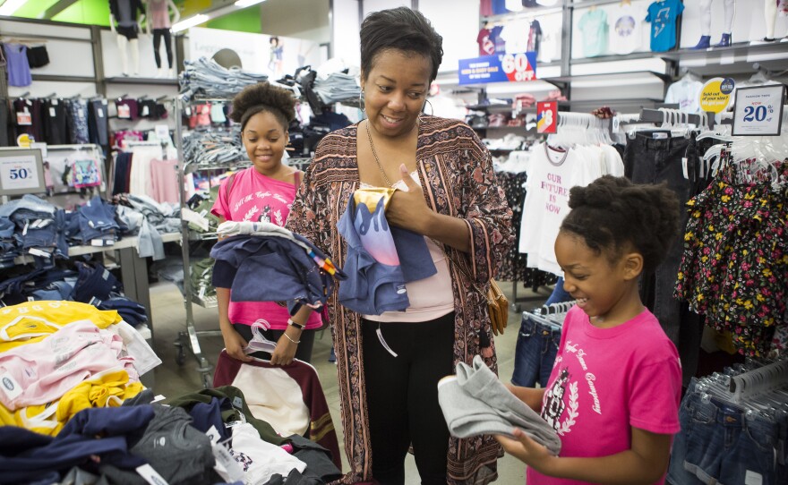 Ayeisha Owens, center, and her daughters Kaiden Clark, left, and Karisma Clark, right, shop for some last minute back-to-school clothes on Saturday, August 18, 2018. Ayeisha insisted that the girls buy clothes that were big enough to last them through next summer as well. She also kept an eye out for anything they could wear once the weather got colder.