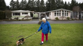 Audrey Behrenhoff walks her dog Emma in front of her home in Redmond last week, at Friendly Village-55 Plus Park, recently purchased by King County Housing Authority. Behrenhoff, 80, has lived in three different mobile homes at Friendly Village.