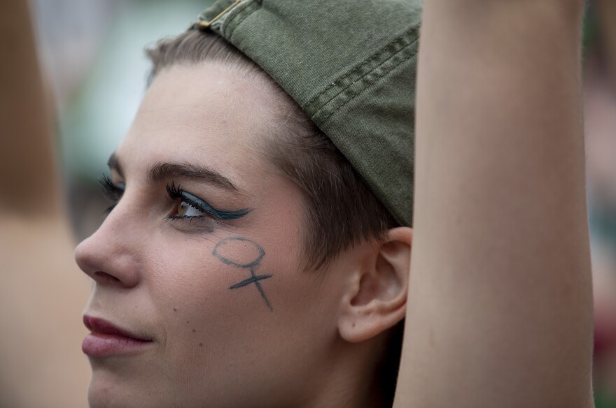 A demonstrator listens at the Women's March in Washington, D.C.