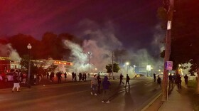 Police in Ferguson fired tear gas to disperse protest crowds Sunday night. 