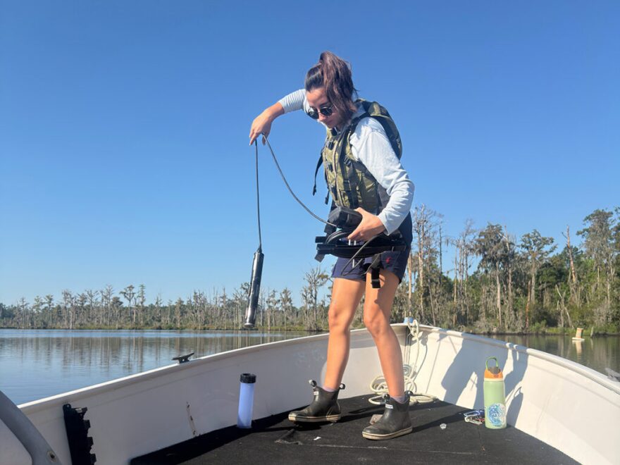 Pamlico-Tar Riverkeeper Katey Zimmerman prepares to drop the YSI sonde into Blounts Creek.