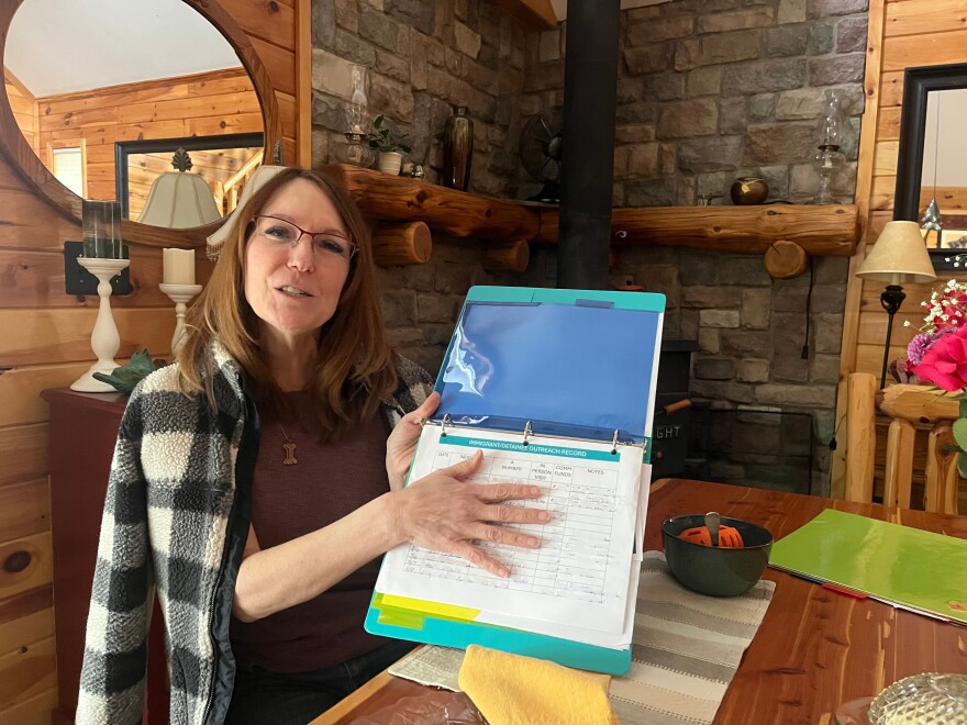 Julie Cordier estimates she's visited between 15 and 20 different people in ICE detention over the past few months, at the detention center just 20 minutes from her home. IPR has blurred the photo where personal information appears on the sheet. (Photo: Claire Keenan-Kurgan/IPR)