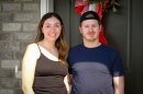 Liz and Hardy Farnsworth stand in front of the front door at their new townhouse in Layton, July 13, 2026. The couple had been in the market for a home for eight years before finding something that fit their family and budget.