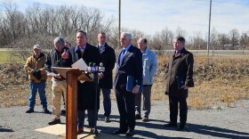 State Senator George Borrello, standing at lectern, speaks at a press conference in Genesee County.