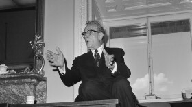 Senator Everett Dirksen (R-Ill.), Senate Minority leader, sits atop a table as he talks with newsmen on Capitol Hill in Washington, D.C., Aug. 3, 1965. (AP Photo/Henry Griffin)