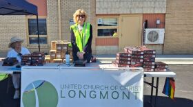 Chris Mason with Heart of Longmont Church and Dede Alspaugh with UCC Longmont (seated) wait for community members to pick up free vehicle gun safes at a giveaway event in Longmont on June 13, 2026. Photo by Maeve Conran.