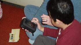 Student uses a handheld communication device. (Courtesy Laura Jenkins-Basdekis)