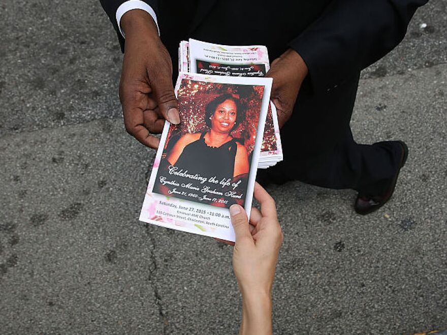 A program with a cover photograph of Cynthia Hurd, 54, is handed out before her funeral at the Emanuel African Methodist Episcopal Church where she was killed along with eight others in a mass shooting at the church on June 27, 2015 in Charleston, South Carolina.