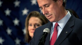 Former Sen. Rick Santorum as he announced the end of his White House bid. His wife, Karen, is in the background.