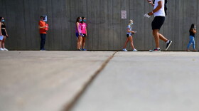 Students wait in line for registration and an identifying wristband after receiving a negative test result for coronavirus while arriving on campus at University of Colorado Boulder on August 18, 2020, in Boulder, Colorado. (Mark Makela/Getty Images)