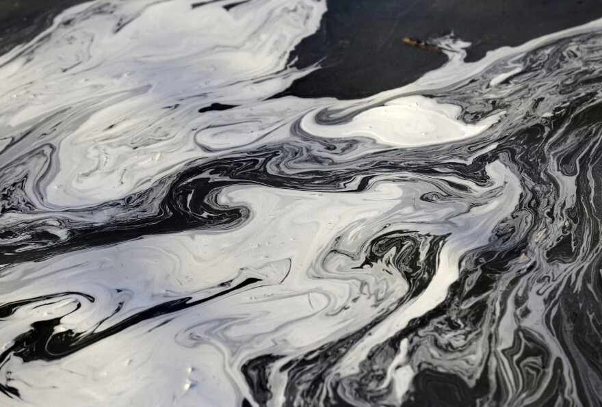 Coal ash swirls on the surface of the Dan River following one of the worst coal-ash spills in U.S. history into the river in Danville, Va., in February 2014. 