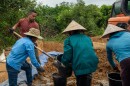 Air Force Master Sgt. Javier Martinez, left, and Vietnamese citizens fill buckets of soil during a Defense POW/MIA Accounting Agency (DPAA) mission in Quang Binh Province, Vietnam, March 29, 2026. The DPAA recovery team was searching for clues to locate the remains of troops missing from the Vietnam War.