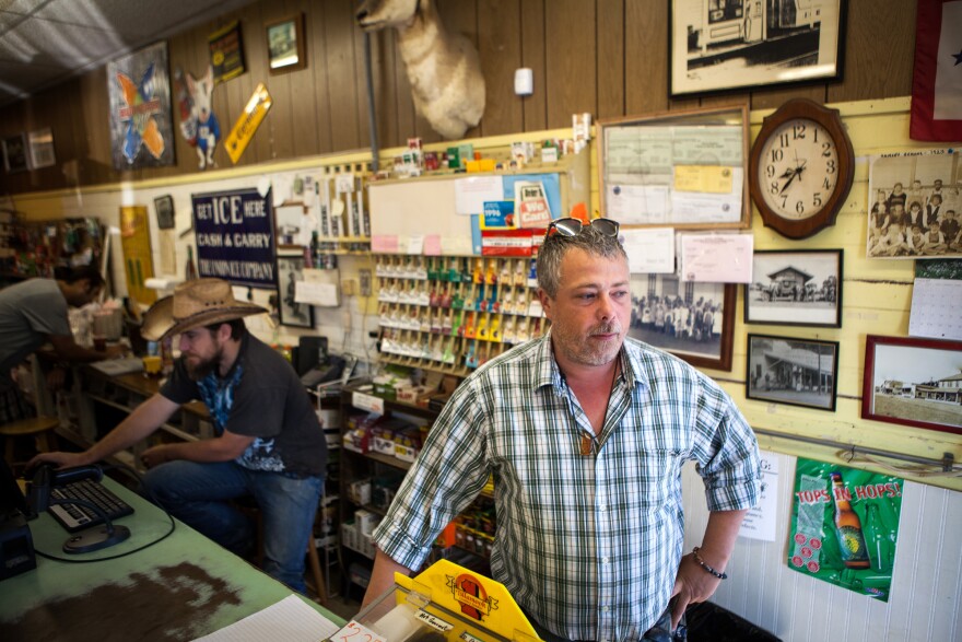 Randen Patterson (right) mans the register at the Corner Store in Guinda.