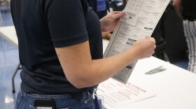 Person stacks ballots
