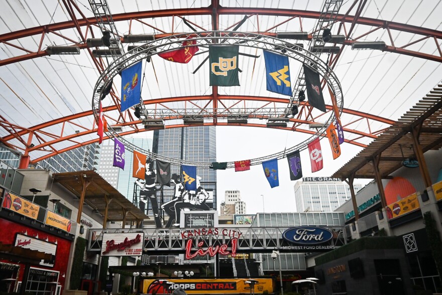  The banners of the Big 12 Conference teams hang above KC Live! venue in anticipation of fans showing up to cheer for their respective teams during the five days of women and men playing hoops at T-Mobile Center and Municipal Auditorium.