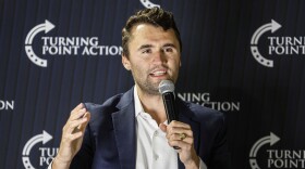 Charlie Kirk speaking into a microphone.