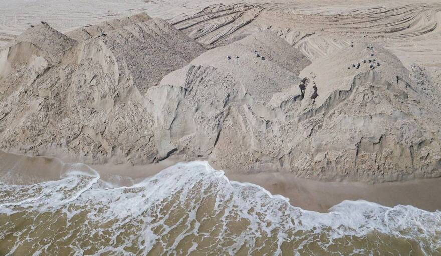 Mounds of sand sit on Miami Beach