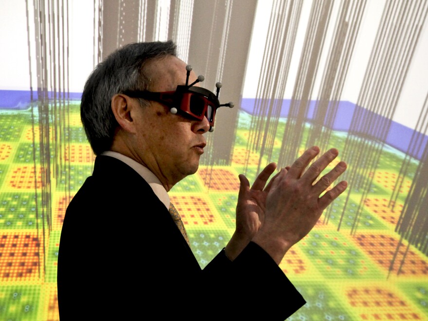 U.S. Energy Secretary Chu stands inside a 3-D imaging "cave," which simulates the inside of a nuclear reactor. The cave, powered by the supercomputers at Oak Ridge National Laboratory, helps scientists to process, view and understand enormous amounts of data visually.