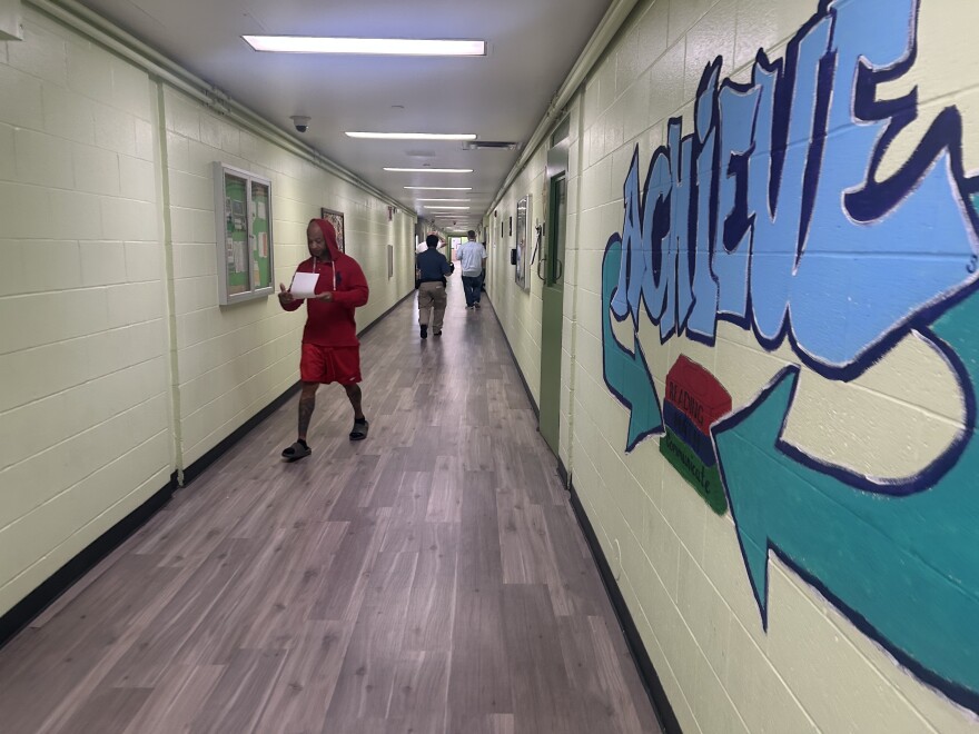 Residents and staff walking within the hallways of the Transition Center.  