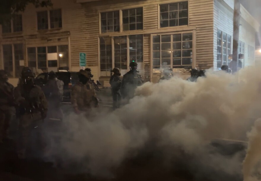 Federal officers spray and throw chemical gases at demonstrators a block up from the ICE processing facility south of downtown Portland on Saturday, Oct. 5, 2025.