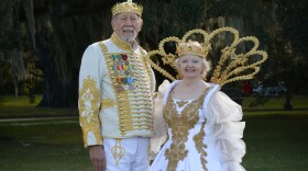 Clif and Lynda Bergeron standing side by side, dressed as the King and Queen of the Krewe of Janus.