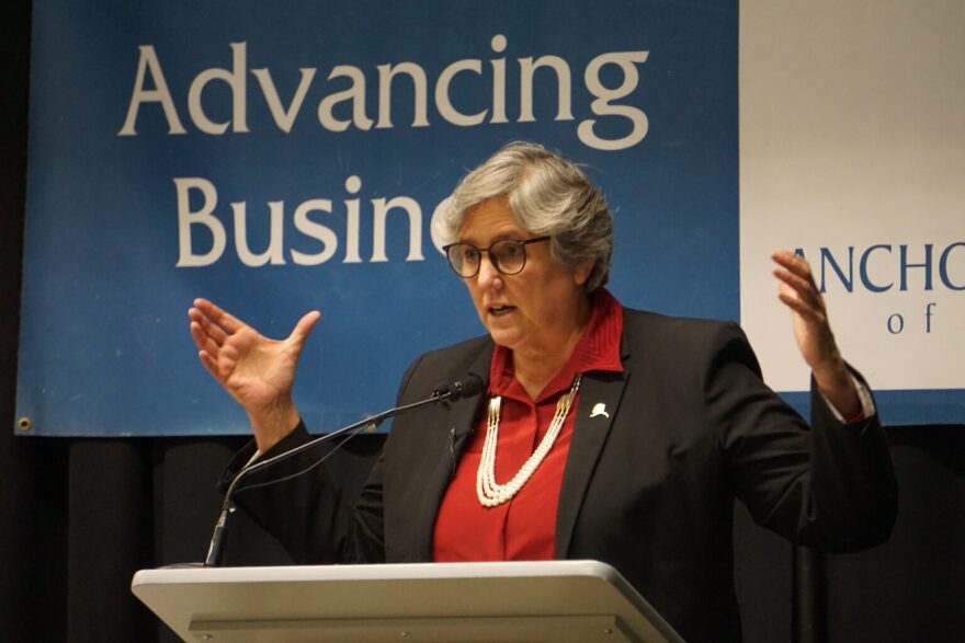 a woman standing behind a lectern