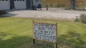 A handwritten yard sign questioning the "secrecy" around a proposed hyperscale data center next door sits in a front yard on Greens Bottom Road in Carroll County.