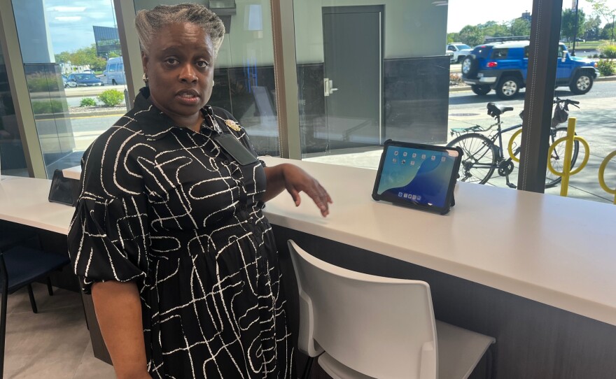 Cathleen Sutherland, the city's director of customer service and success, demonstrates the Self-Service Center in the lobby of the new South Bend City Hall.