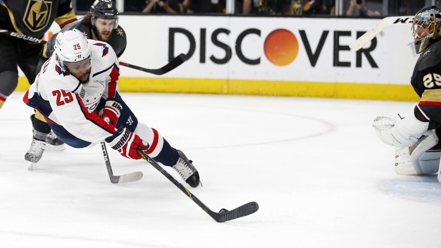 Washington Capitals right wing Devante Smith-Pelly, left, scores the winning goal against Vegas Golden Knights goaltender Marc-Andre Fleury while falling to the ice Thursday during the third period in Game 5 of the NHL hockey Stanley Cup Finals in Las Vegas.