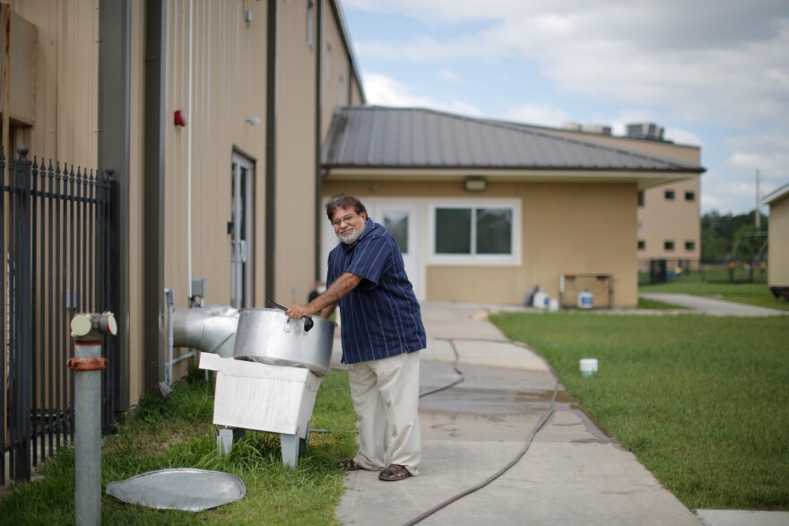 Haniff Moton, one of the founders of the mosque, cleans out a large pot from lunch. He served chicken stew and "no one complained about my cooking," he says. He had to leave the mosque before cleaning the pot to meet his wife at the hospital because she needed her dialysis. It was bothering him that the pot wasn't cleaned so he came back to take care of it.