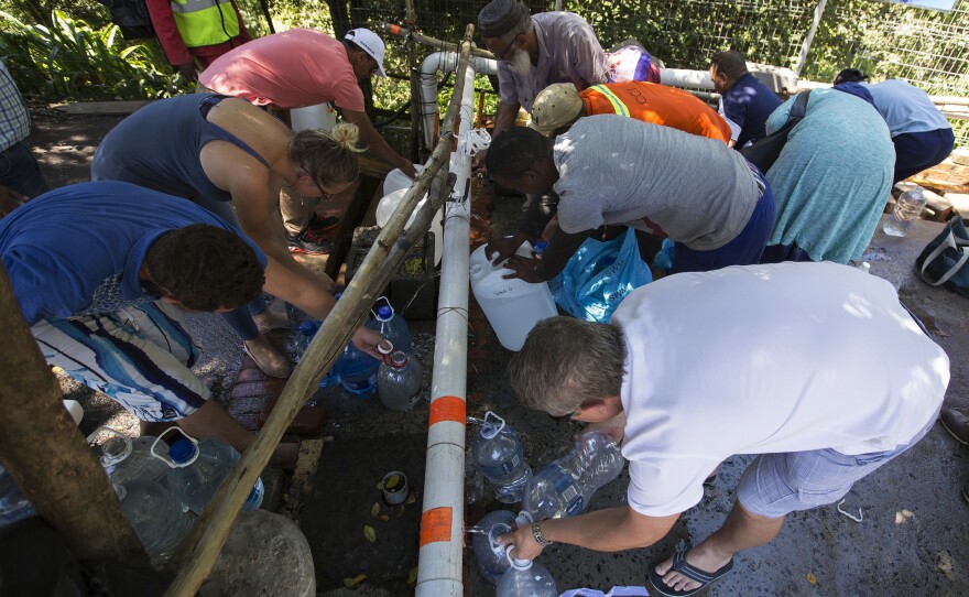 Residents fill containers with water in Cape Town, South Africa, on Feb. 1. Officials say the city could run out of water in April. It's just one of many challenges facing South Africa.