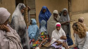Dionne Searcey, far right, doing reporting as a part of her work as West Africa bureau chief for the New York Times. 