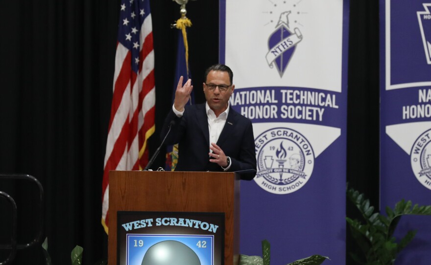 Gov. Josh Shapiro makes a "W" with his fingers, the sign for West Scranton.