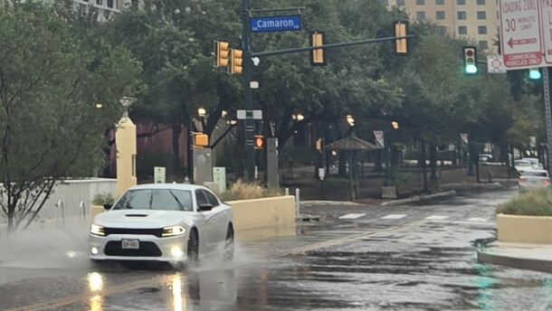 A car splashes its way down Houston Street downtown on Oct. 1, 2026