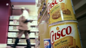 Crisco was the original product made with partially hydrogenated soybean oil, which contains trans fats. Today, Crisco has only small amounts of the fats.