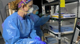 Nurse Chris Rutledge suits up in personal protective equipment before entering the patient wards of a COVID-19 field hospital, Friday, Jan. 15, 2021, in Lenoir, N.C.