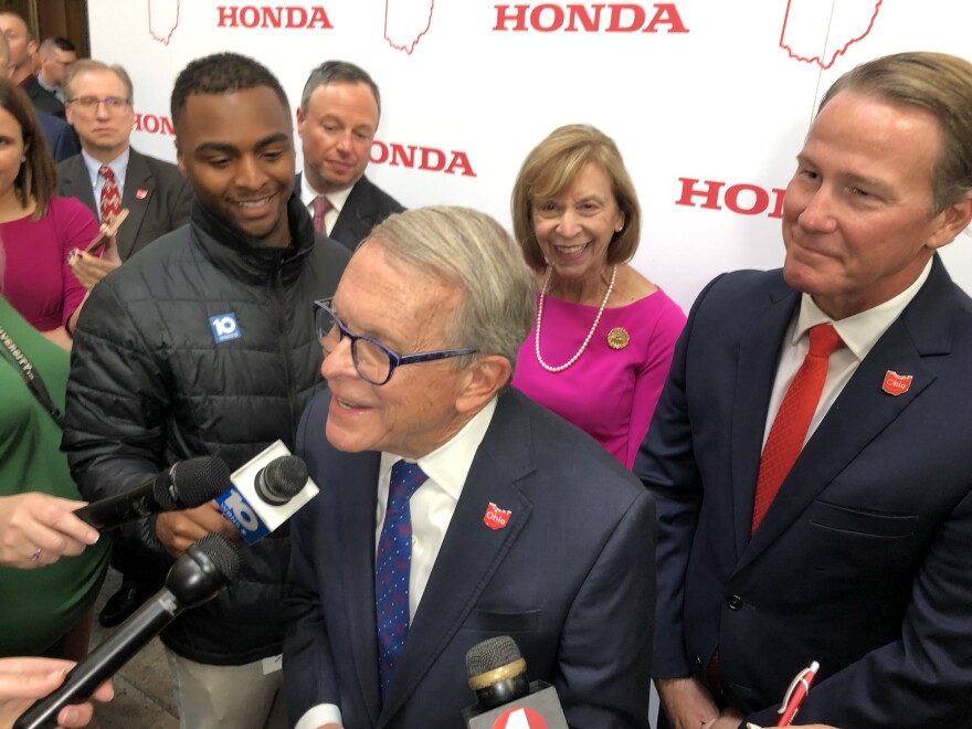 Gov. Mike DeWine (R-Ohio) celebrates Honda announcement with Lt. Gov. Jon Husted (R-Ohio) and First Lady Fran DeWine at the Ohio Statehouse on October 11.