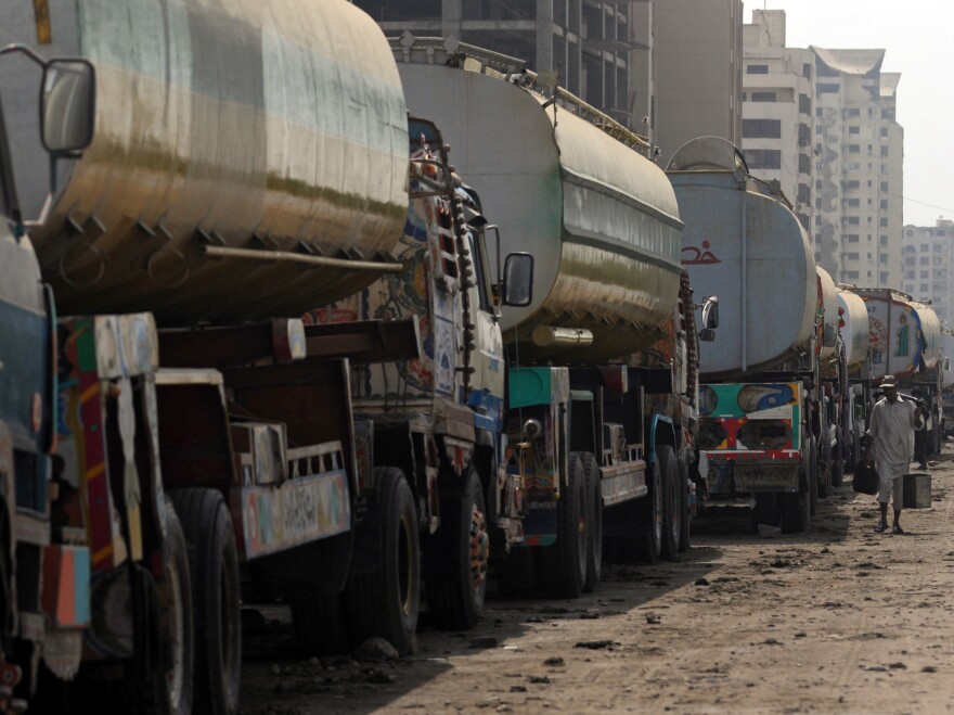 Fuel trucks are backed up in Karachi, Pakistan. U.S. negotiators spent more than a month talking with Pakistan about reopening supply routes from Pakistan to Afghanistan. Pakistan reportedly wants about $3,000 for each trip, while the U.S. is reportedly offering about $1,000.