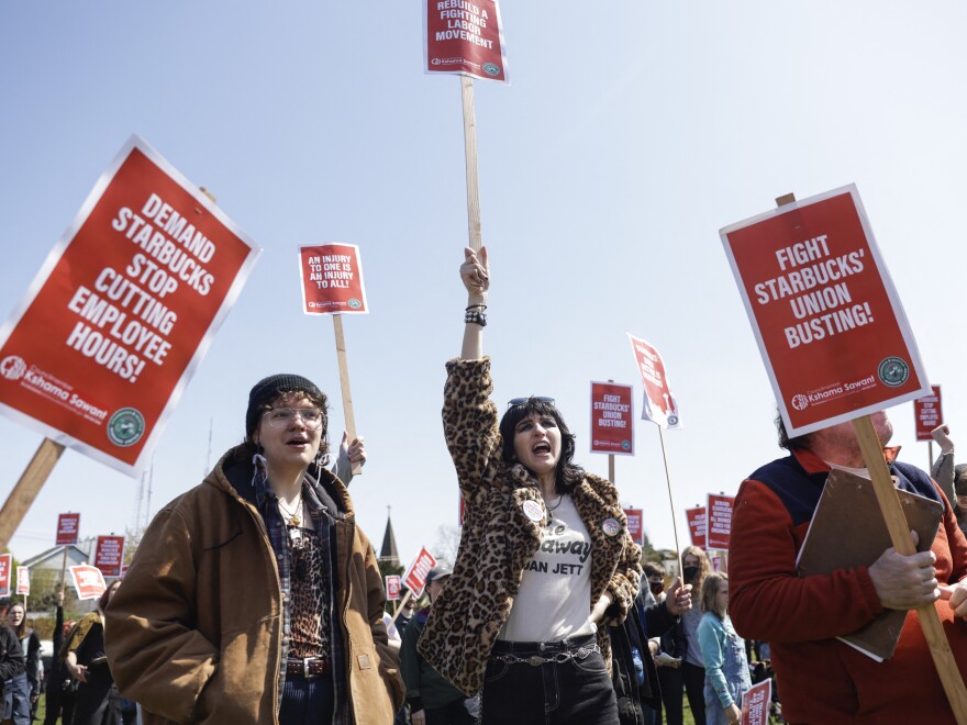 Marchers raise picket signs during a "Fight Starbucks' Union Busting" rally held in Seattle in April.