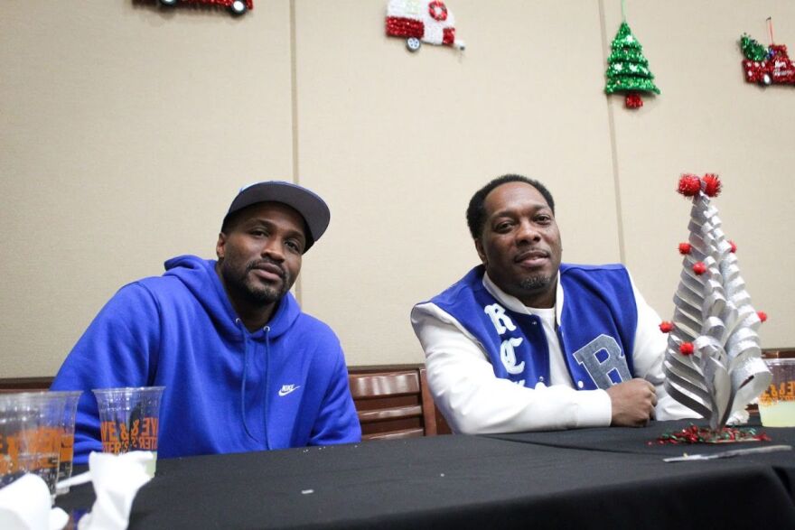 Michael White, left, and Derrick House, right, on the northeast side of Indianapolis on Thursday, Dec. 11, 2025 at the You Yes You! holiday party. Both men, who were incarcerated, participated in the program, which helps connects incarcerated fathers and their children.