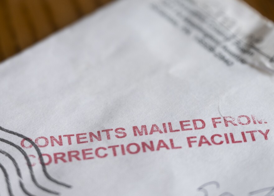 A photo of an envelope stamped in red with the words: content mailed from correctional facility (Nate Smallwood/For Spotlight PA)