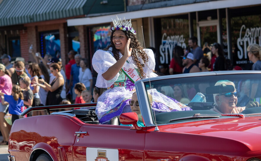 Miss Westfest 2026 Kierstyn Powers waves to the crowd during the Westfest parade on Saturday. As part of the 50th anniversary celebrations, the parade also included a float featuring past winners of the Miss Westfest pageant.