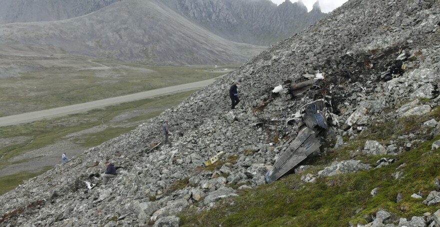 Investigators with the National Transportation Safety Board are seen on Aug. 23, 2026 documenting wreckage of a Cessna 441 that crashed on Cape Newenham in Southwest Alaska three days earlier, killing all eight people on board.